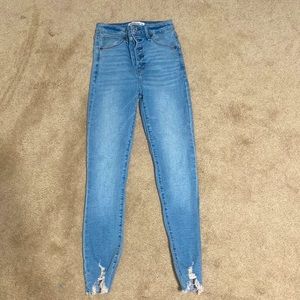 Washed pair of blue jeans. High rise super skinny ankle fit.
